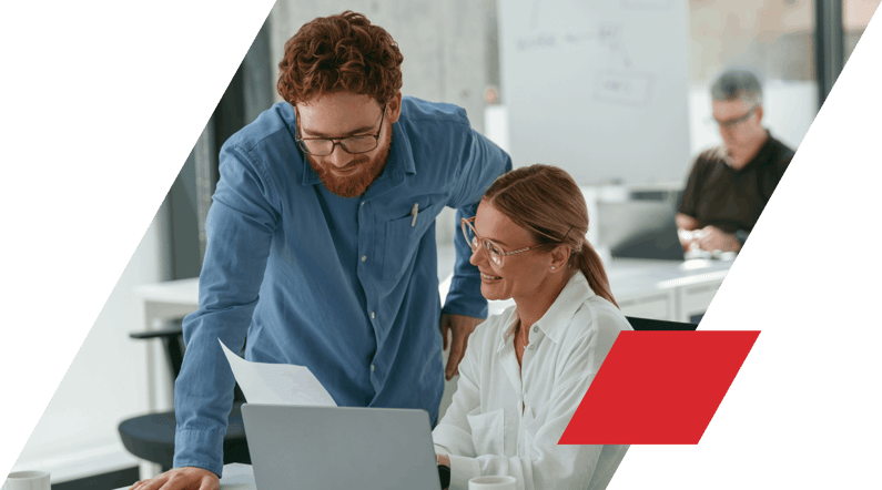 Man and woman in shirts looking at data together