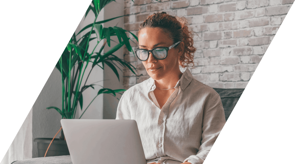 Woman on sofa looking at laptop