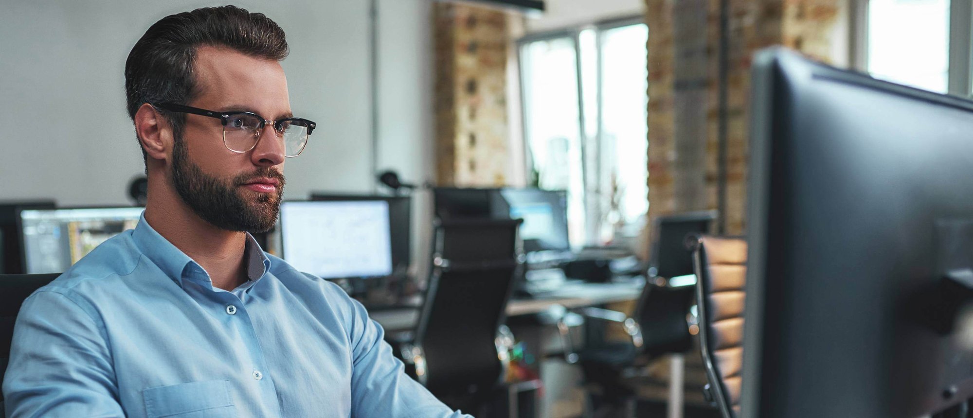 Man in blue shirt looking at computer screen