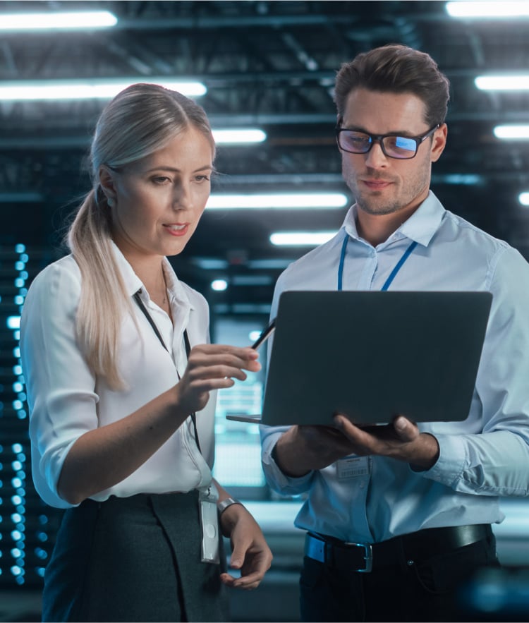 Woman and man standing and looking at laptop together-mobile