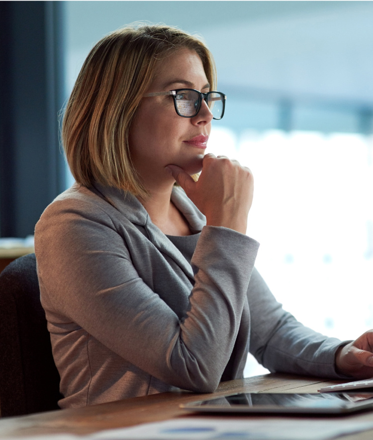 Focused woman in suit looking at computer screen-mobile