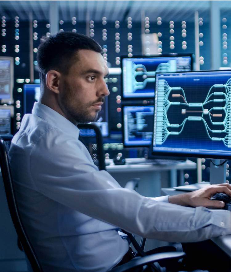 Man in shirt looking at data on computer screens-mobile