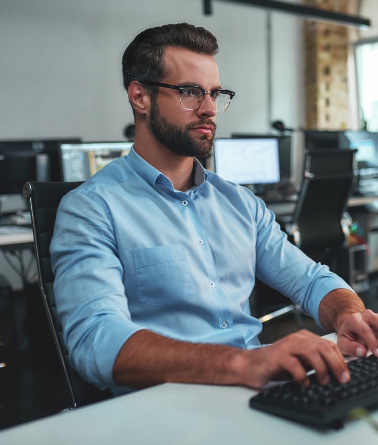 Man in blue shirt looking at computer screen-mobile