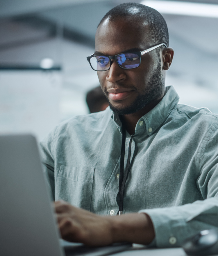 Man with glasses looking at laptop screen-mobile